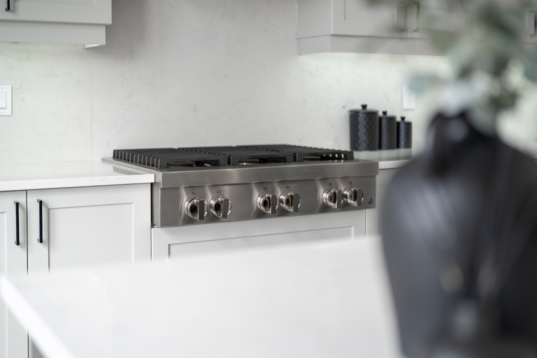 Modern stainless steel gas range in a bright kitchen.