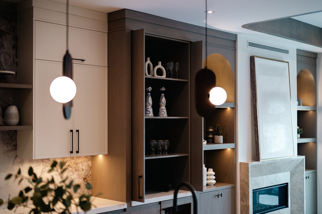 Modern kitchen with open shelving and pendant lights.