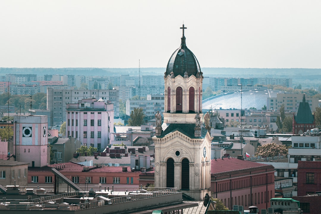 Church steeple towers over the city's buildings.