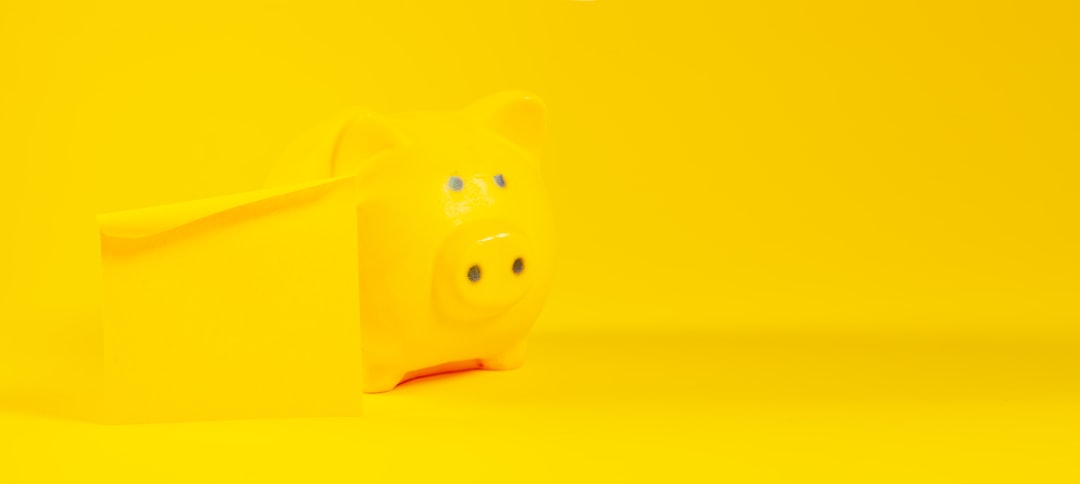 A yellow piggy bank sits against a yellow background.