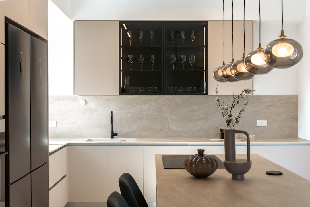 Modern kitchen with sleek cabinets and pendant lights.